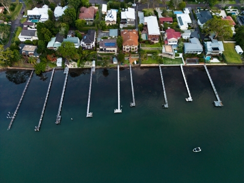 Jetties protruding from homes along the shore of Brisbane Water, Gosford - Australian Stock Image