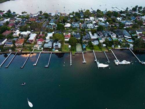 Jetties protruding from homes along the shore of Brisbane Water, Gosford - Australian Stock Image