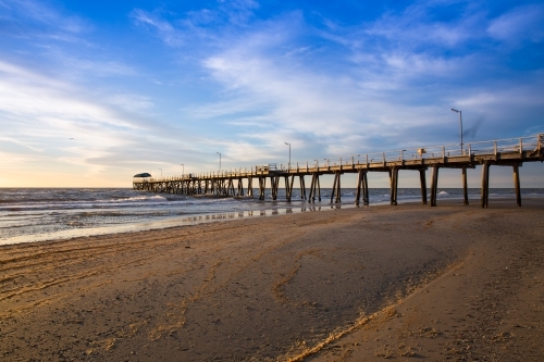 jetty at sunset under wispy clouds - Australian Stock Image