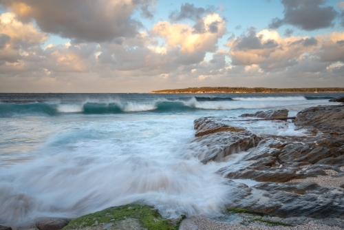 Jibbon Head at sunset with blurred waves in the foreground - Australian Stock Image