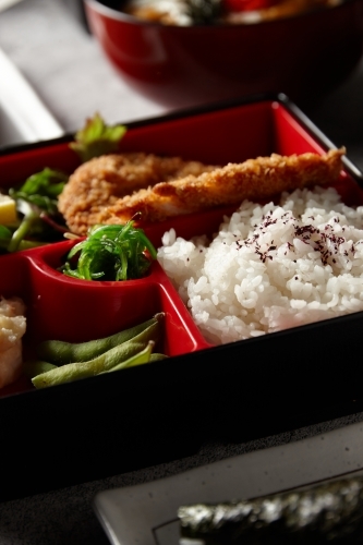 Katsu bento box with rice, meat, and vegetables - Australian Stock Image