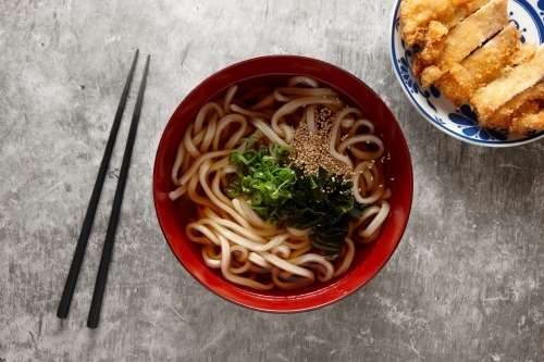Katsu soy noodles in bowl - Australian Stock Image