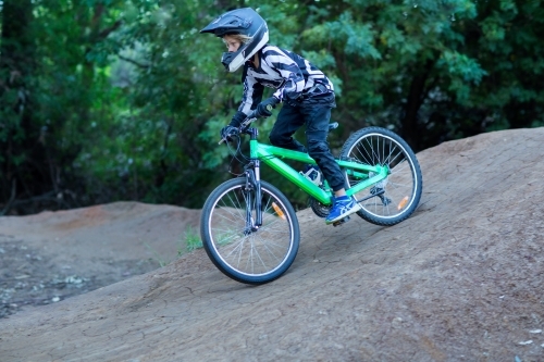 Kid on bike wearing helmet - Australian Stock Image