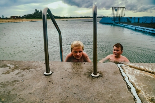 Kids swimming in the Ocean Baths swimming pool at Forster, New South Wales Australia - Australian Stock Image