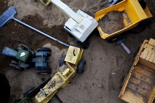 Kids toy trucks in a sandpit from above - Australian Stock Image