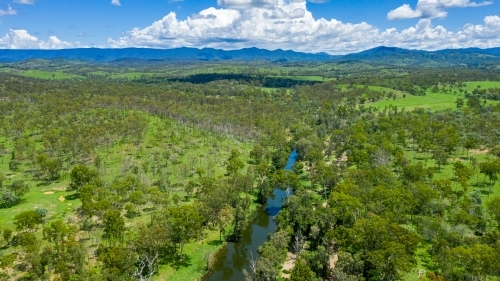 Kroombit Tops National Park summer landscape with fresh water creek and vibrant green vegetation - Australian Stock Image