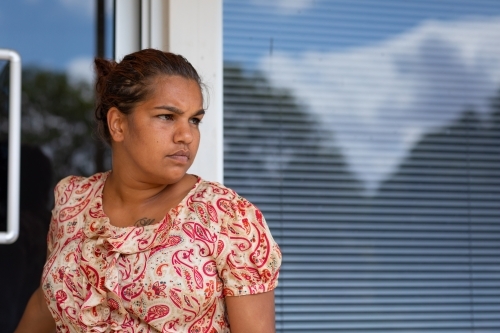 lady leaving building outside the door - Australian Stock Image