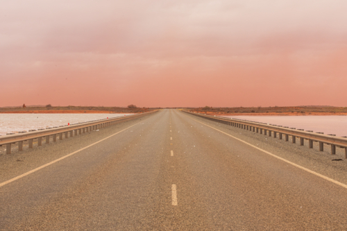 Landscape image of Onslow road in a dust storm. with salt lakes either side - Australian Stock Image