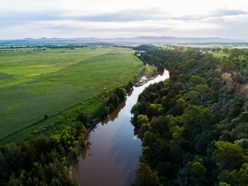 Landscape of cliff, river and green farmland - Australian Stock Image