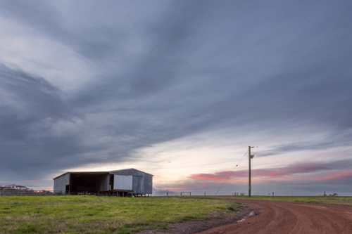 Landscape of shearing shed at sunset - Australian Stock Image