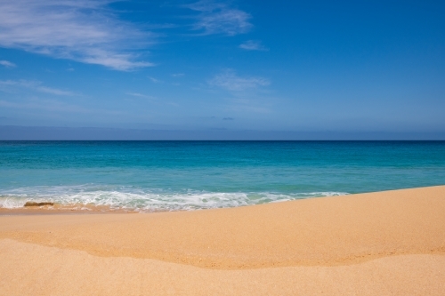 Landscape view of sand and ocean, and blue sky - Australian Stock Image