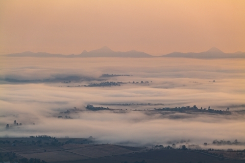 Landscape with early morning  fog and low clouds in the Scenic Rim - Australian Stock Image
