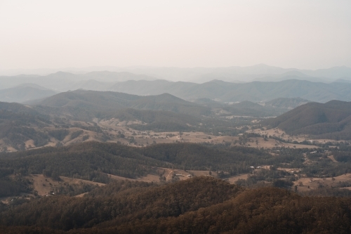 Landscape with hazy mountain views behind a valley in regional New South Wales. - Australian Stock Image