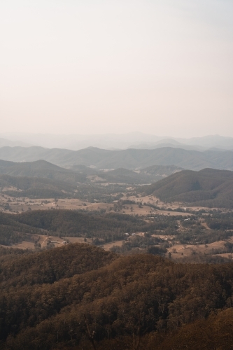 Landscape with hazy mountain views behind a valley in regional New South Wales. - Australian Stock Image