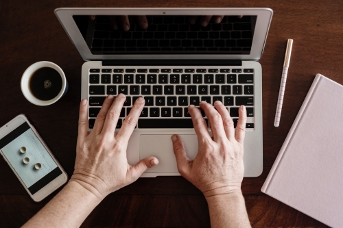 laptop with journal and coffee - Australian Stock Image