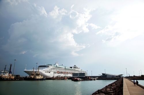 Large cruise liner docked at an industrial port - Australian Stock Image