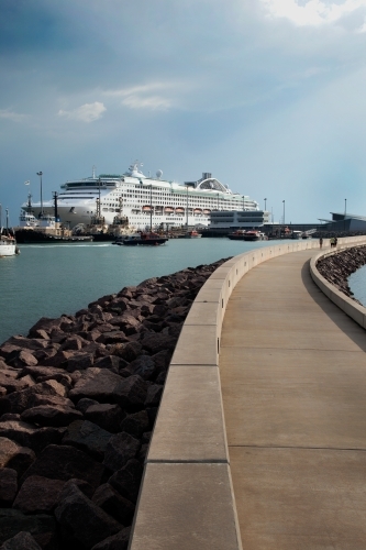 Large cruise liner docked at an industrial port - Australian Stock Image