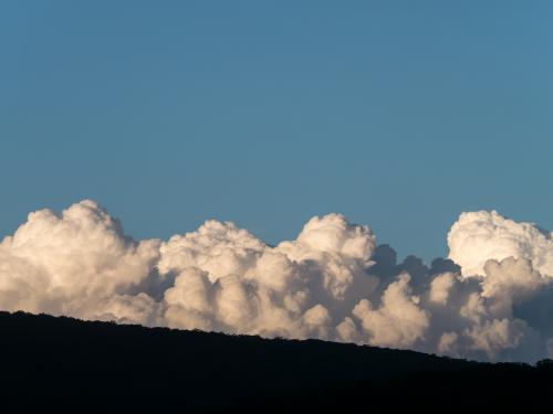 Large cumulus clouds with blue sky above - Australian Stock Image