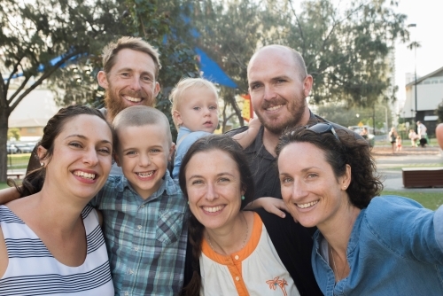 Large group of friends and family taking a photo of themselves in the park - Australian Stock Image