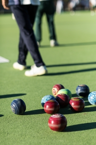 Lawn bowls on bowing green with bowlers behind