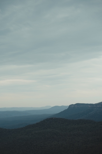 Layers of mountains into the distance during blue hour in the Blue Mountains. - Australian Stock Image