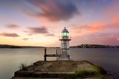 Lighthouse on Sydney Harbour with a sunrise sky - Australian Stock Image