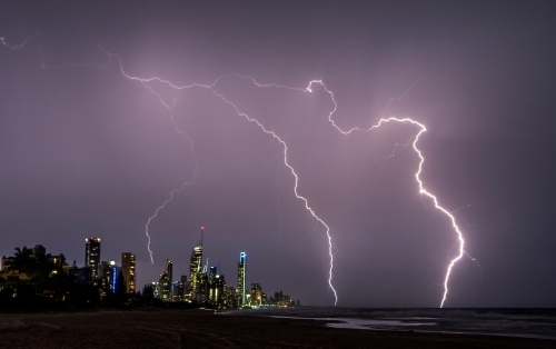 Lightning bolts across the night sky against the Gold Coast cityscape - Australian Stock Image