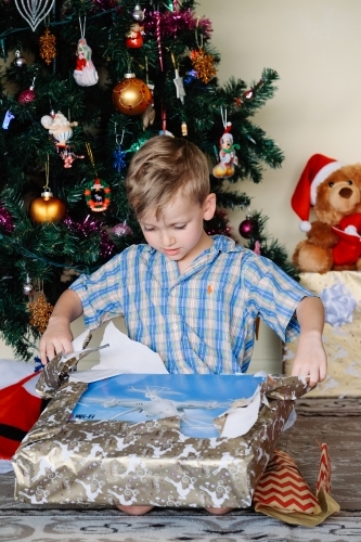 Little boy opening a drone on Christmas day - Australian Stock Image