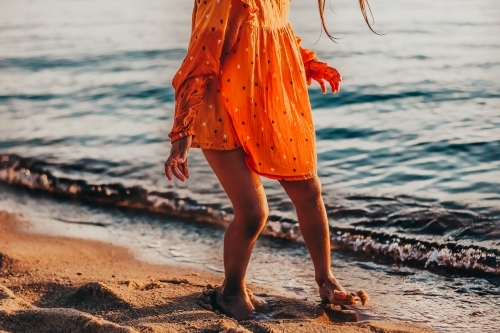 Little girl at the beach and waves - Australian Stock Image