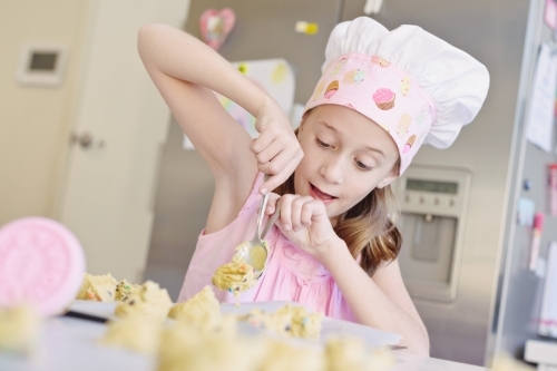 little girl baking at home in the kitchen