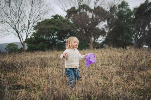 Little girl playing in a field