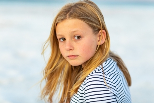 little girl with looking over shoulder at camera - Australian Stock Image