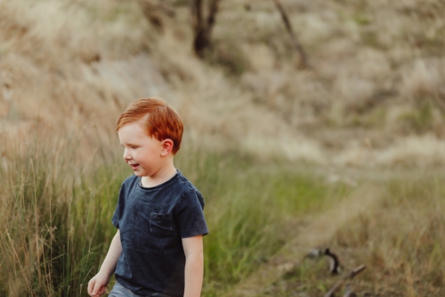 Little red head boy exploring in the Australian bush - Australian Stock Image