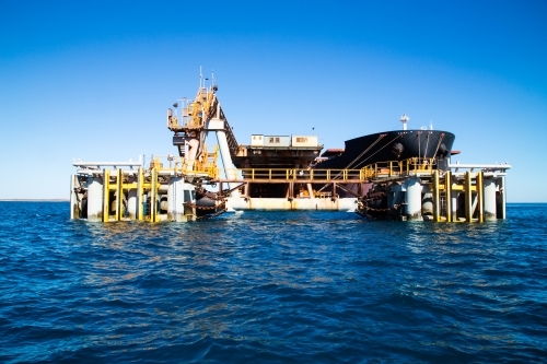 Loading facility with freight ship docked - Australian Stock Image