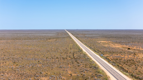 Long straight road on a vast barren land. - Australian Stock Image