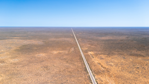 Long straight road on a vast barren land. - Australian Stock Image