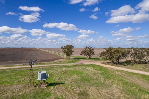 Looking down at a windmill and water tank in a rural setting - Australian Stock Image