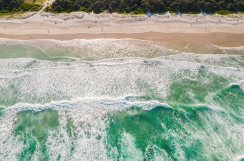 Looking down at ocean colours as the water flows into the sand. - Australian Stock Image