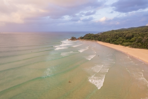 Looking down at the layers of waves heading into shore at the end of the day along the coast - Australian Stock Image