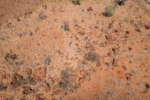 Looking down at the stony texture with red dirt - Australian Stock Image