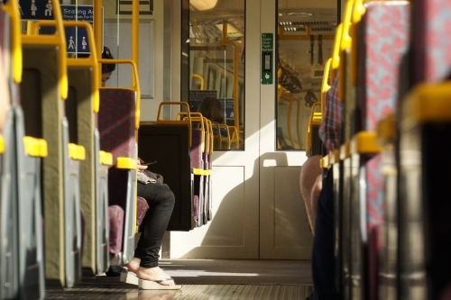 Looking down the aisle of a train during daily commute - Australian Stock Image