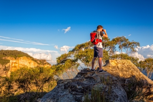 Looking out across the mountains and escarpment from a rocky cliff that juts out from main escarpmen - Australian Stock Image