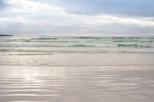 Looking out at calm ocean under afternoon clouds - Australian Stock Image