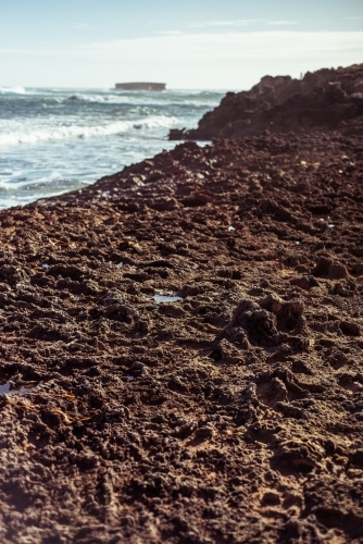 Looking out over rocky surface to ocean