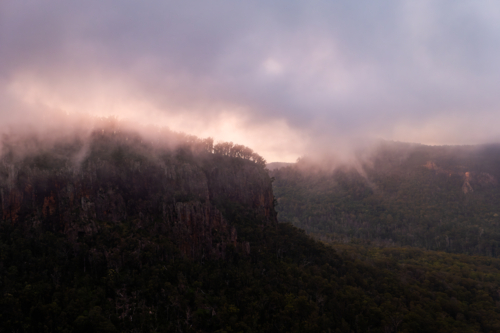low cloud above steep mountain landscape - Australian Stock Image