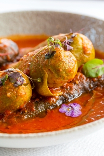 Mahashi with rich tomato sauce served in a white deep dish. - Australian Stock Image