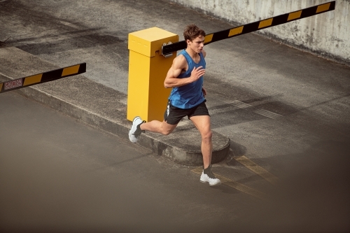 Male runner running through urban setting - Australian Stock Image