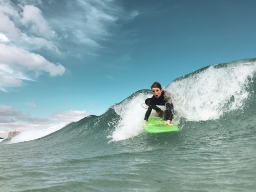 Male youth surfing a soft board - Australian Stock Image