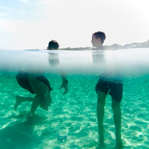 Man and Boy under and above water exploring - Australian Stock Image