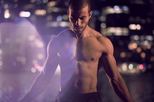 Man fitness training in urban area at night - Australian Stock Image